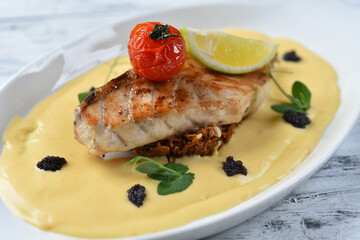 grilled fish fillet with vegetable puree, tomatoes and lemon