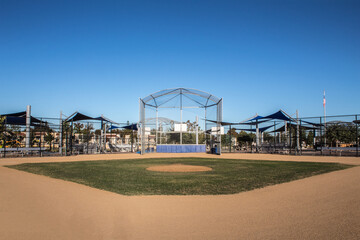 Fototapeta na wymiar Full view of baseball field diamond, pitcher's mound and batting cage.