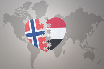 puzzle heart with the national flag of norway and yemen on a world map background. Concept.