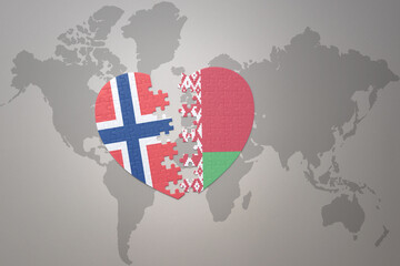 puzzle heart with the national flag of norway and belarus on a world map background. Concept.