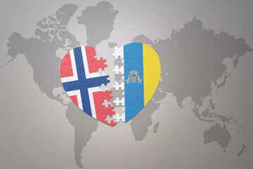 puzzle heart with the national flag of norway and canary islands on a world map background. Concept.