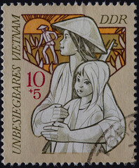 GERMANY, DDR - CIRCA 1971: a postage stamp from GERMANY, DDR, showing an armed Vietnamese woman...