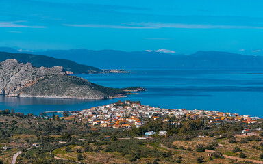 Fototapeta na wymiar From a low peak on the island of Aegina, Greece, we see the town of Perdika, the Moni and Agistri islands, and in the background the Peloponnese.