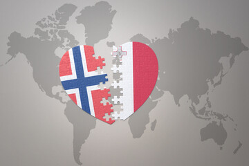 puzzle heart with the national flag of norway and malta on a world map background. Concept.