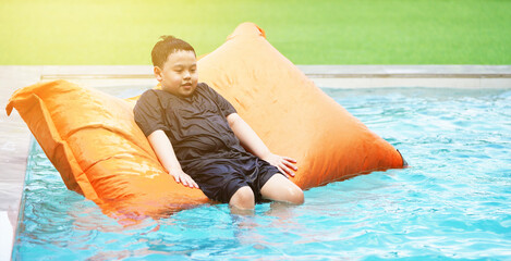 boy on float in swimming pool