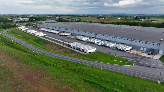 Massive warehouse for freight shipping in USA. American distribution center aerial reveal in America.