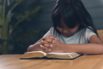 Praying child with bible