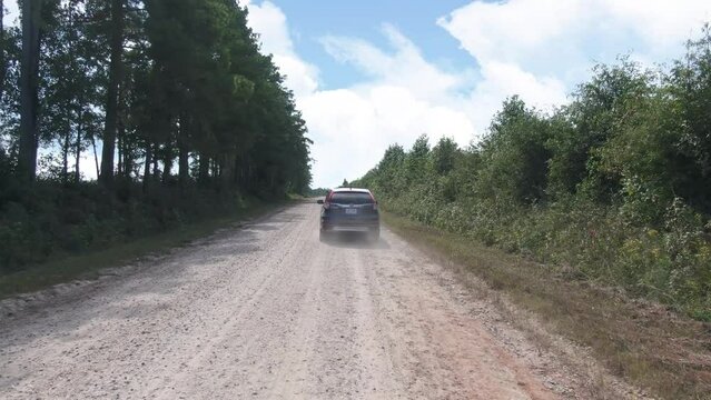 Small SUV Traveling on Gravel Road.