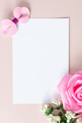 Cute sparkly toys and flowers on light-pink background with space for text. Template for a card...