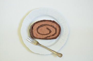 Piece of Chocolate tart on white Plate, isolated on white Background