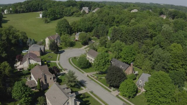 A slowly forward moving aerial view of a typical Pennsylvania residential neighborhood's cul-de-sac. Pittsburgh suburbs.  	