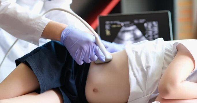 Ultrasound doctor make ultrasound of abdomen and kidneys of child