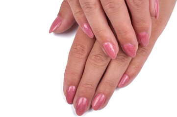 closeup of hands of a young woman with long pink manicure on nails isolated on white background