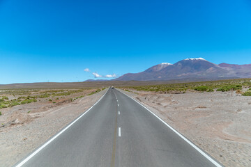 road in the mountains between the cliffs overlooking the snowy hills