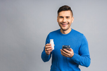 Happy Young ukrainian Handsome Man drinking probiotic Yogurt isolated over grey white Background....