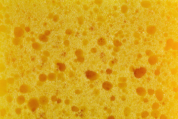 Dishwashing sponge texture close up photo. Yellow sponge pattern macro photography. - obrazy, fototapety, plakaty