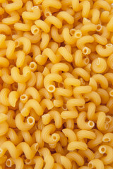 Cavatappi dry pasta organic product background yellow