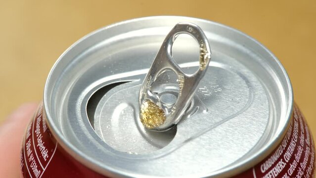 Anonymous man opening a generic soft drink new small 330 ml metal can of soda, macro top part extreme closeup, object detail. Carbonated sugary drinks, beverage aluminum can container, object up close