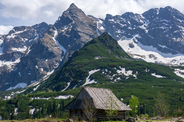 An old hut in the background of the Koscielec peak. Gasienicowa Valley. Tatra Mountains.