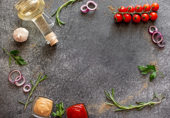 Fototapeta na wymiar Gray stone background for cooking. Spices and vegetables. View from above. Free space for your text