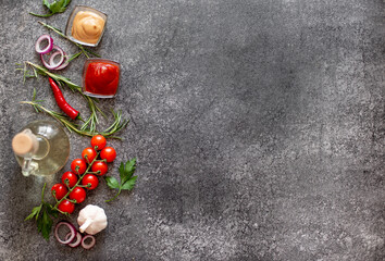 Gray stone background for cooking. Spices and vegetables. View from above. Free space for your text