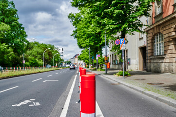 Separated bike lane on a main street in Berlin to improve road safety at the expense of parking lane.