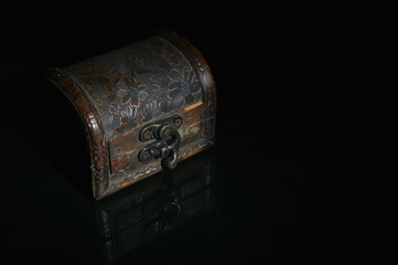 Old wooden treasure chest isolated on a black background