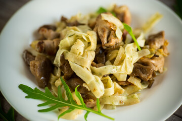 Homemade boiled noodles with meat and eggplant in a plate