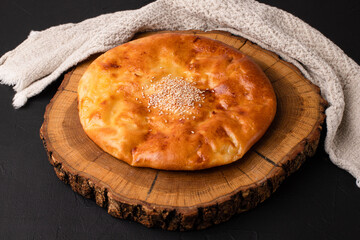 Khachapuri, khachapuri on a black background, Georgian cuisine