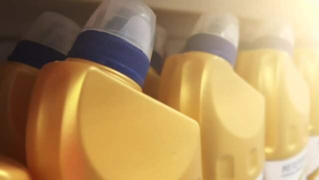 Concentrated toilet cleaning gels in plastic bottles stand on a supermarket shelf. Closeup shot