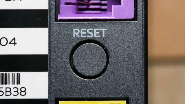 Reset button on an electronic device, router, WiFi access point, resetting, turning on and off, nobody, object detail macro Restarting reloading return to default settings abstract concept, technology
