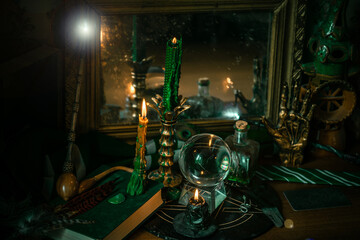 Illustration of magical stuff....candle light, Chrystal ball, magic wand, book of spells dark...