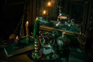 Illustration of magical stuff....candle light, Chrystal ball, magic wand, book of spells dark...