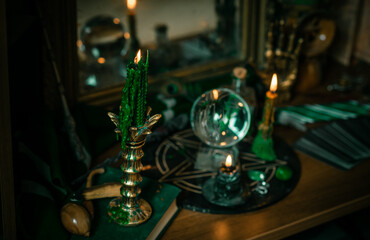 Illustration of magical stuff....candle light, Chrystal ball, magic wand, book of spells dark...