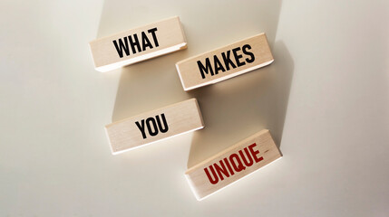 What Makes You Unique written on wooden blocks and white background