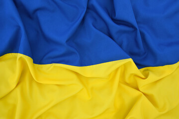 Fabric bent national flag of Ukraine, UA.