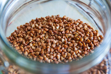 Buckwheat in a jar, gluten free antique grain for a healthy diet, selective focus