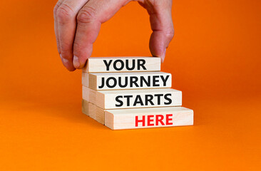 Your journey starts here symbol. Concept words Your journey starts here on wooden blocks on a beautiful orange table orange background. Business, motivational and your journey starts here concept.