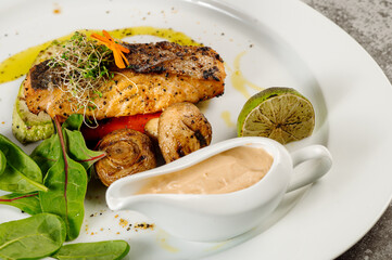 Grilled salmon fish steak with mushrooms and herbs on grey concrete background - 508099301