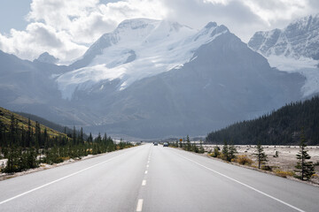 Alpine highway leading to the massive mountain with snow and glaciers, Jasper, Canada