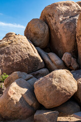 peculiar rock formations of big boulders of rock in Joshua Tree national Park in California on a clear ,blue summer's day.