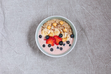 Healthy oatmeal with yoghurt, blueberries, strawberries, banana and seeds. Healthy fitness meal, superfood. 