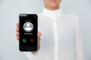 Woman showing phone with incoming call from unknown caller on white background, closeup. Be careful - fraud