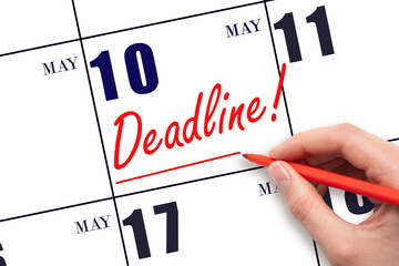 Hand drawing red line and writing the text Deadline on calendar date May 10. Deadline word written...
