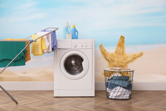 Beautiful wallpaper with image of starfish and seascape in laundry room