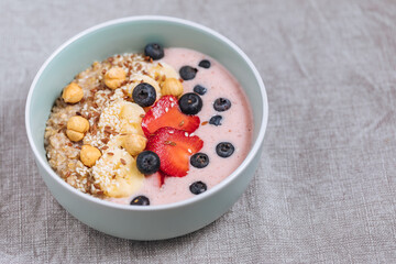 Healthy oatmeal with yoghurt, blueberries, strawberries, banana and seeds. Healthy fitness meal, superfood. 