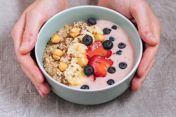Healthy oatmeal with yoghurt, blueberries, strawberries, banana and seeds. Healthy fitness meal, superfood. 