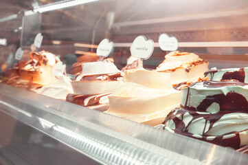 Showcase with different kinds of ice cream, closeup view