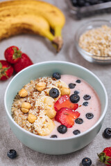 Healthy oatmeal with yoghurt, blueberries, strawberries, banana and seeds. Healthy fitness meal, superfood. 