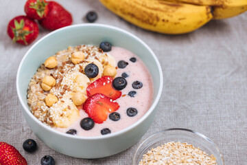 Healthy oatmeal with yoghurt, blueberries, strawberries, banana and seeds. Healthy fitness meal, superfood. 